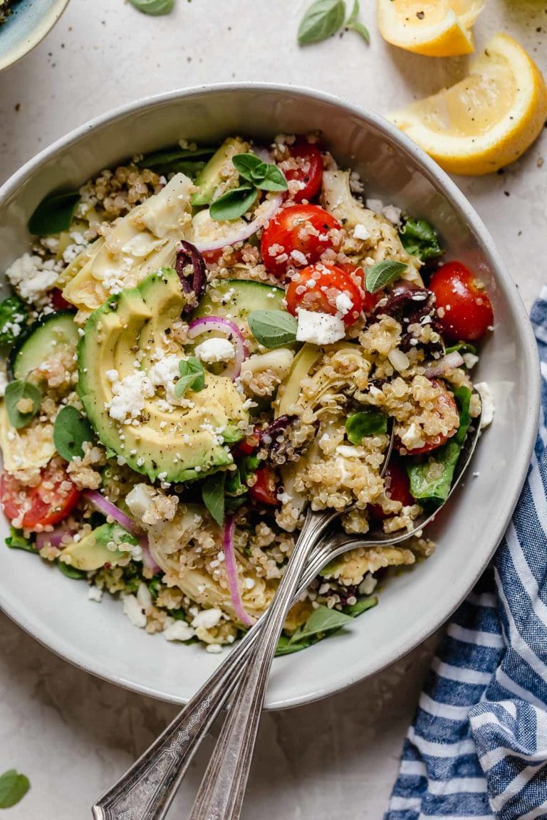 Overhead view of a stone bowl filled with Greek quinoa salad with feta cheese
