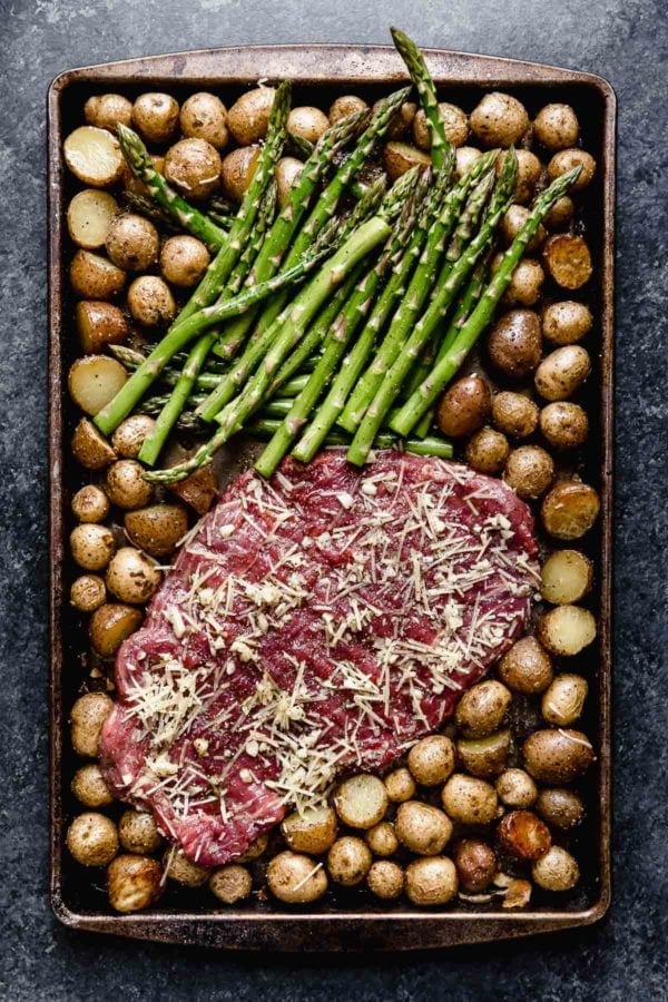 Overhead view of Sheet Pan Parmesan Steak and Potatoes ready for baking