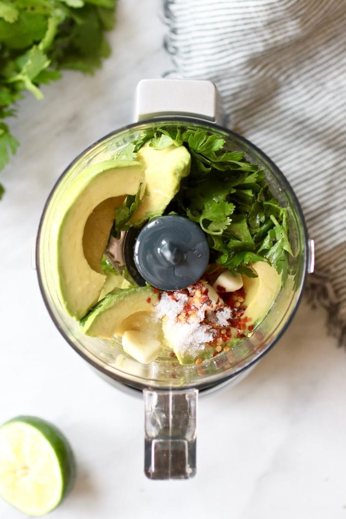 Photo of Avocado Green Sauce ingredients in a food processor