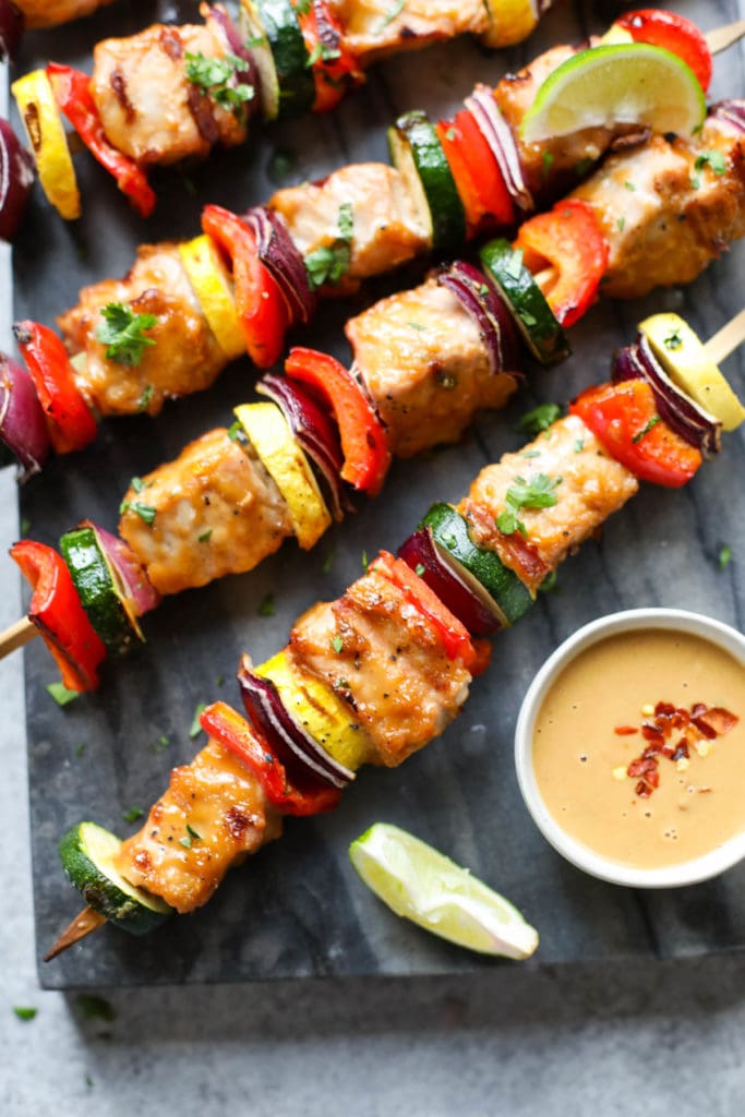Overhead view of several Grilled Pork Kebabs with Peanut Sauce