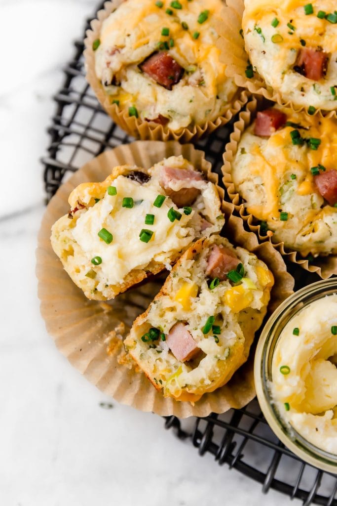 Savory Ham & Cheese Muffins cut open and served with butter