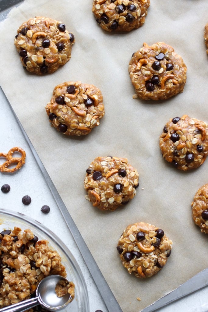 A cookie sheet with Peanut Butter Chocolate Chip Pretzel Cookies ready to go in the oven.