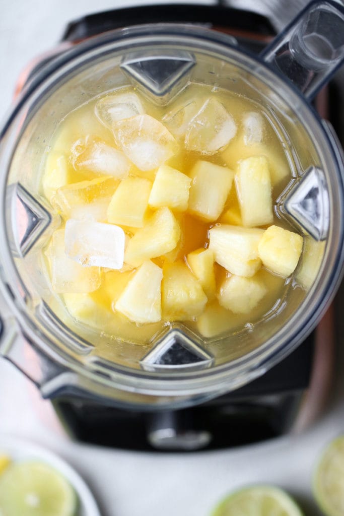Overhead shot of blender filled with ingredients for the Frozen Pineapple Margaritas