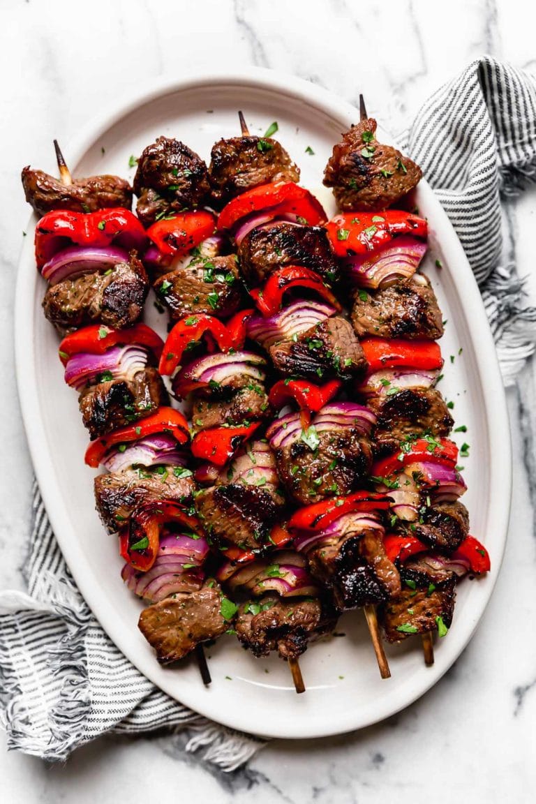 Overhead view of 4 Grilled Steak Kebabs with red peppers and onions Ready to Eat