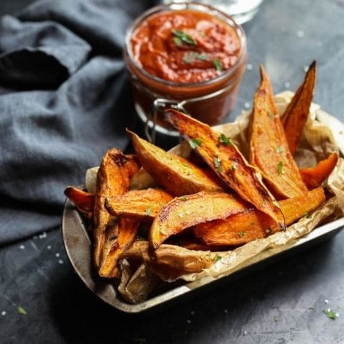 CLose up of BBQ Sauce with Roasted Sweet Potato Wedges on a plate
