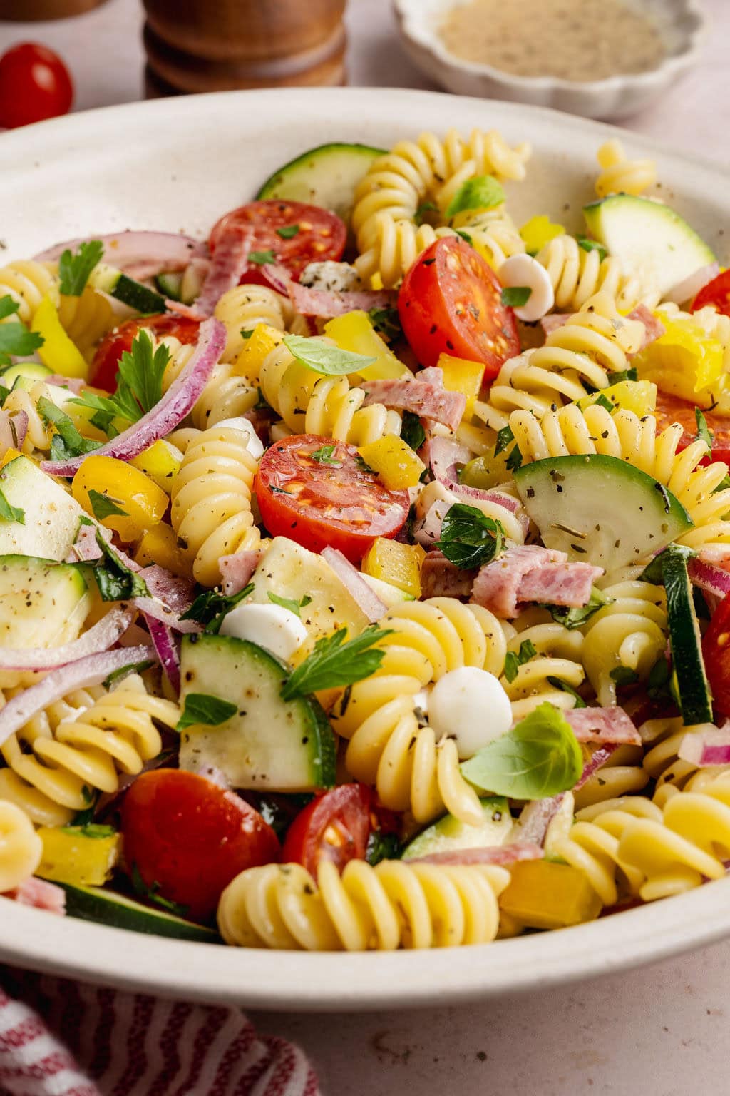 Close up view of a colorful Zesty Italian Pasta Salad topped with an Italian dressing.
