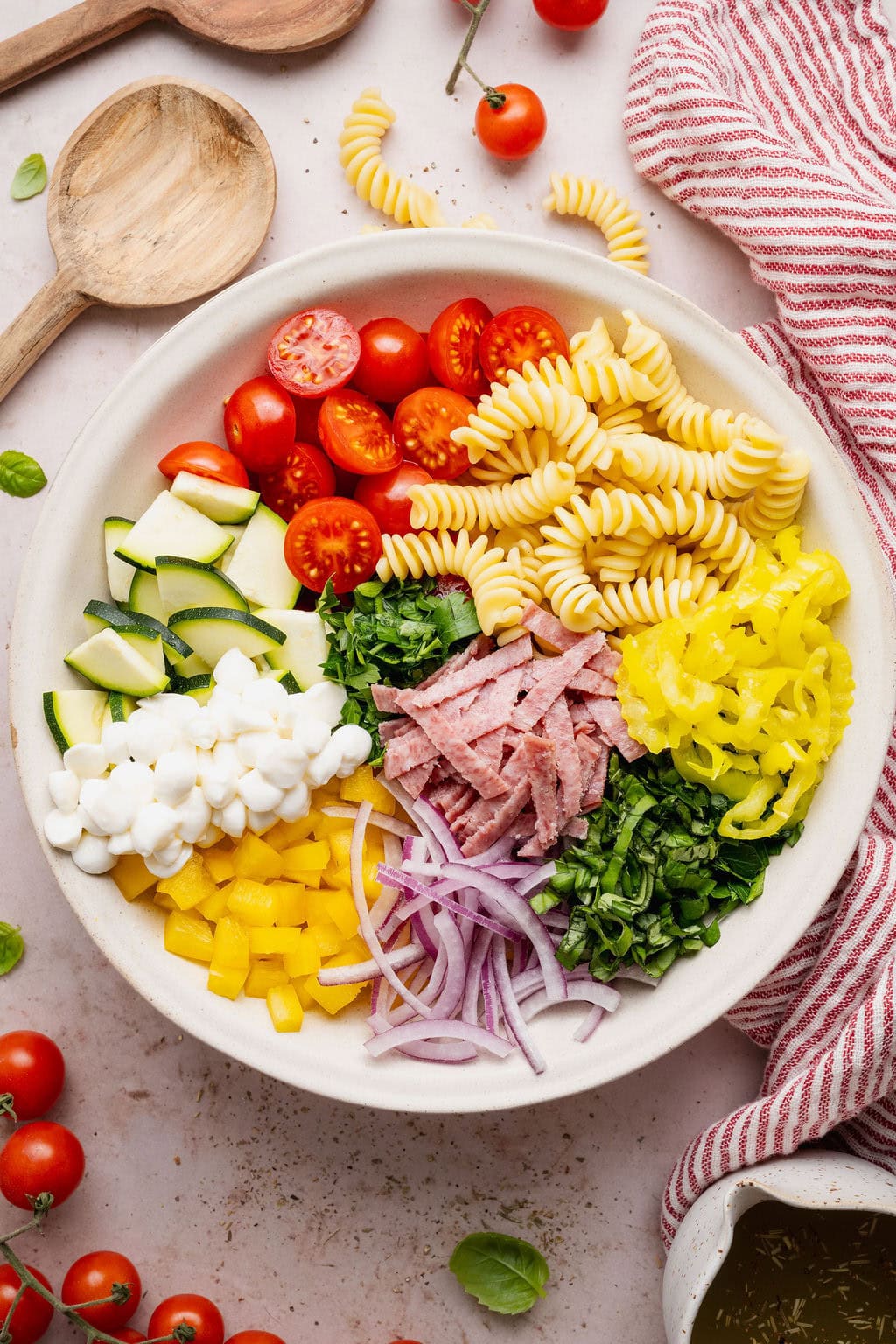 Overhead view of a Zesty Italian Pasta Salad arranged in sections ready for stirring.