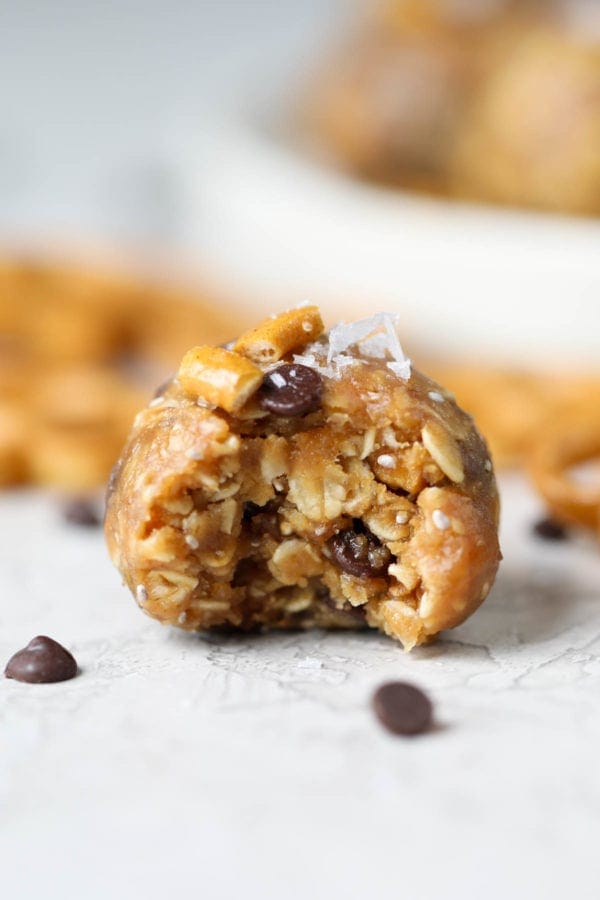 One gluten-free peanut butter bite with a bite taken out of it.