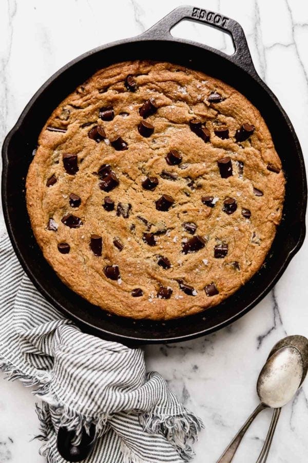 Baked Chocolate Chip Cookie Skillet in a cast iron pan sprinkled with sea salt fresh from the oven.