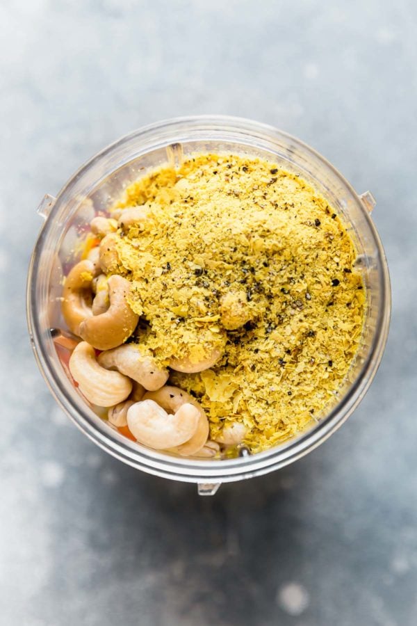 A blender jar filled with grain free bread crumb ingredients ready for the blender.