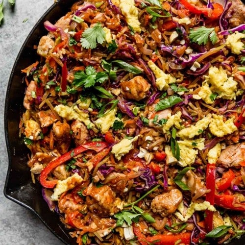 Cast iron skillet filled with chicken pad thai