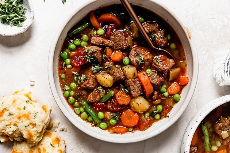Overhead view of a bowl of vegetable beef soup. 