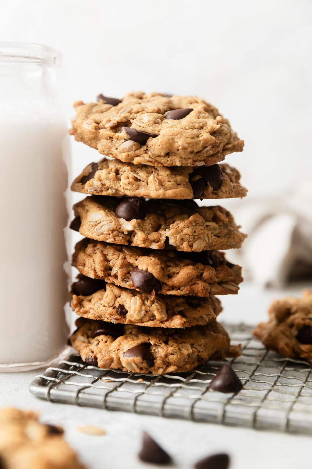 Close up view of a stack of Peanut Butter Oatmeal Cookies with Chocolate Chips on a wire cooling rack.