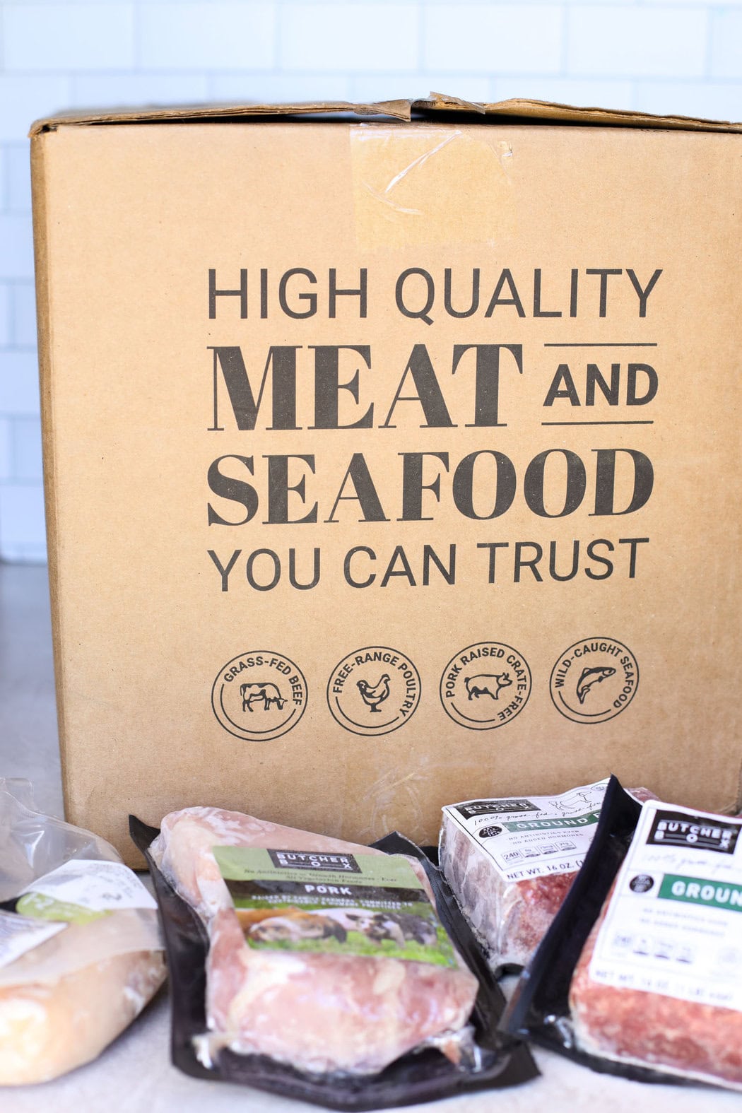 A large brown box of a variety of butcher box meats. 