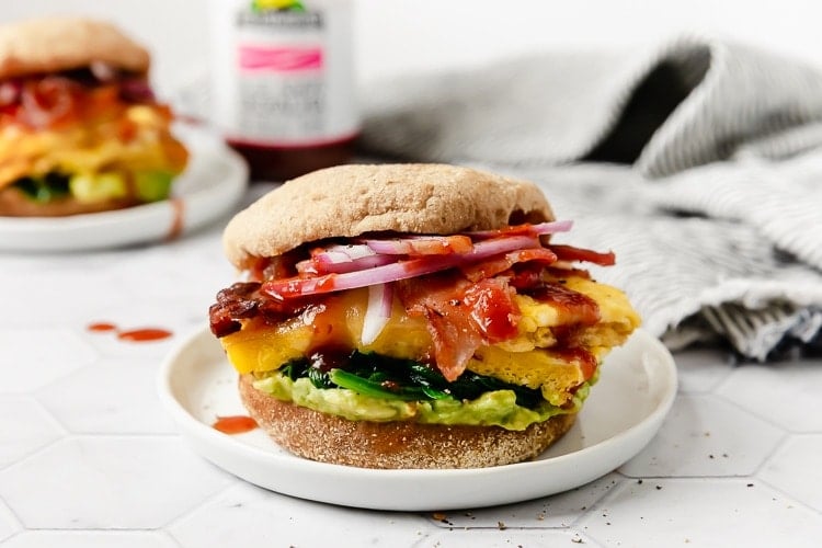 A breakfast sandwich on a plate that was made and frozen previously. 