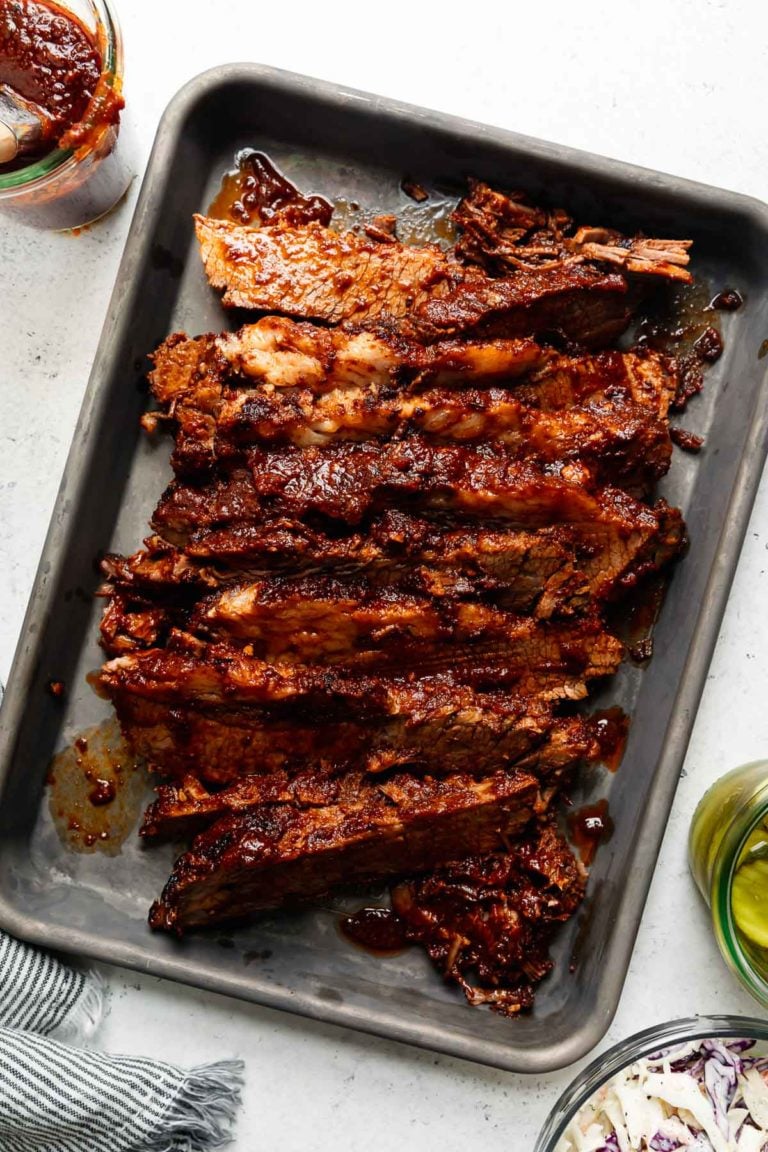 Overhead view of a sheet pan filled with BBQ Brisket sliced thin.
