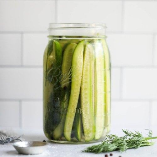 A jar of refrigerator pickles on a counter