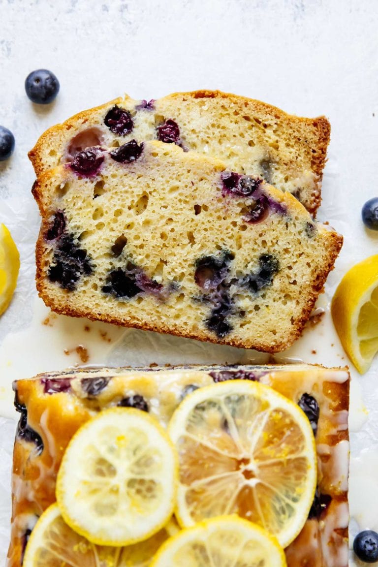 Overhead view of a loaf of lemon blueberry bread with a glaze on top.