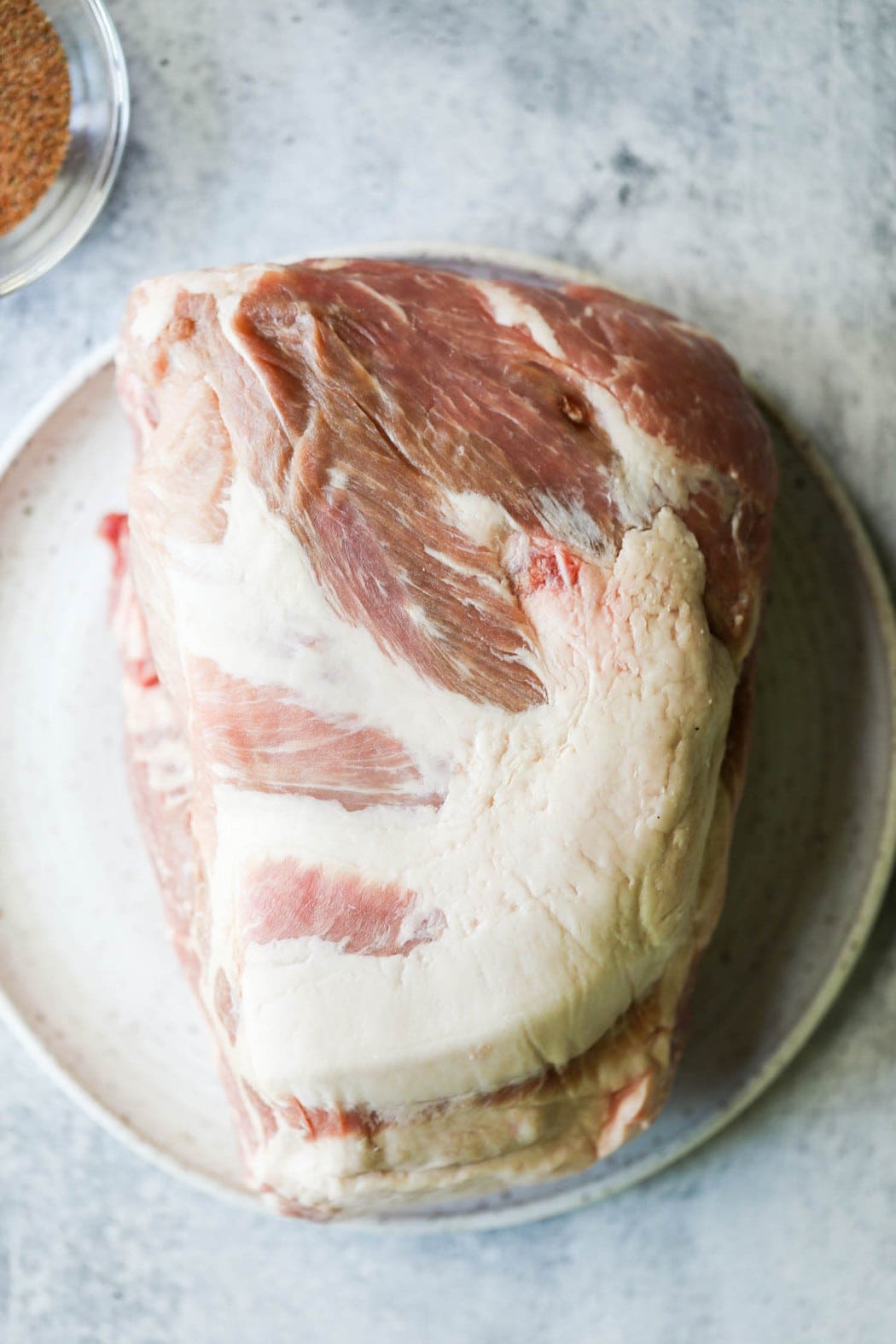 Seasoned smoked pork butt on a serving plate