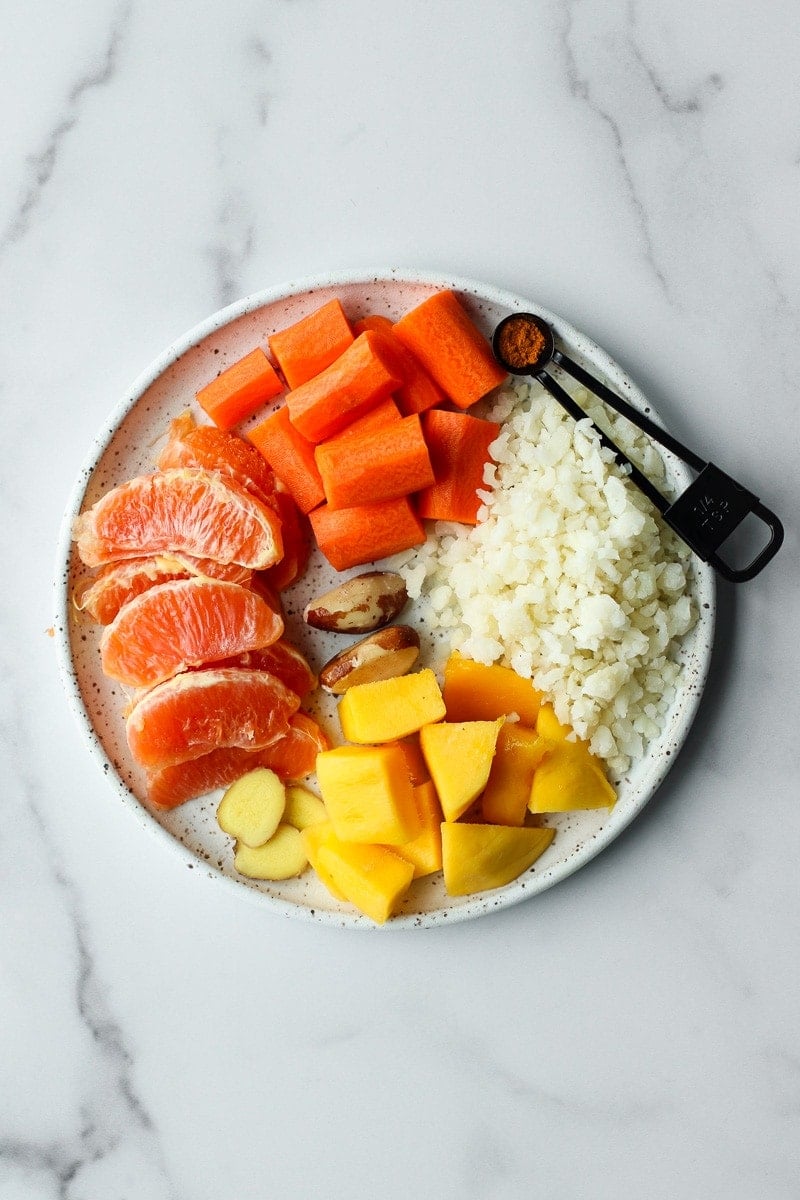 A plate filled with all ingredients for orange smoothie bag
