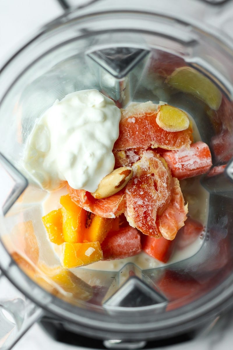 All ingredients for orange smoothie in a blender