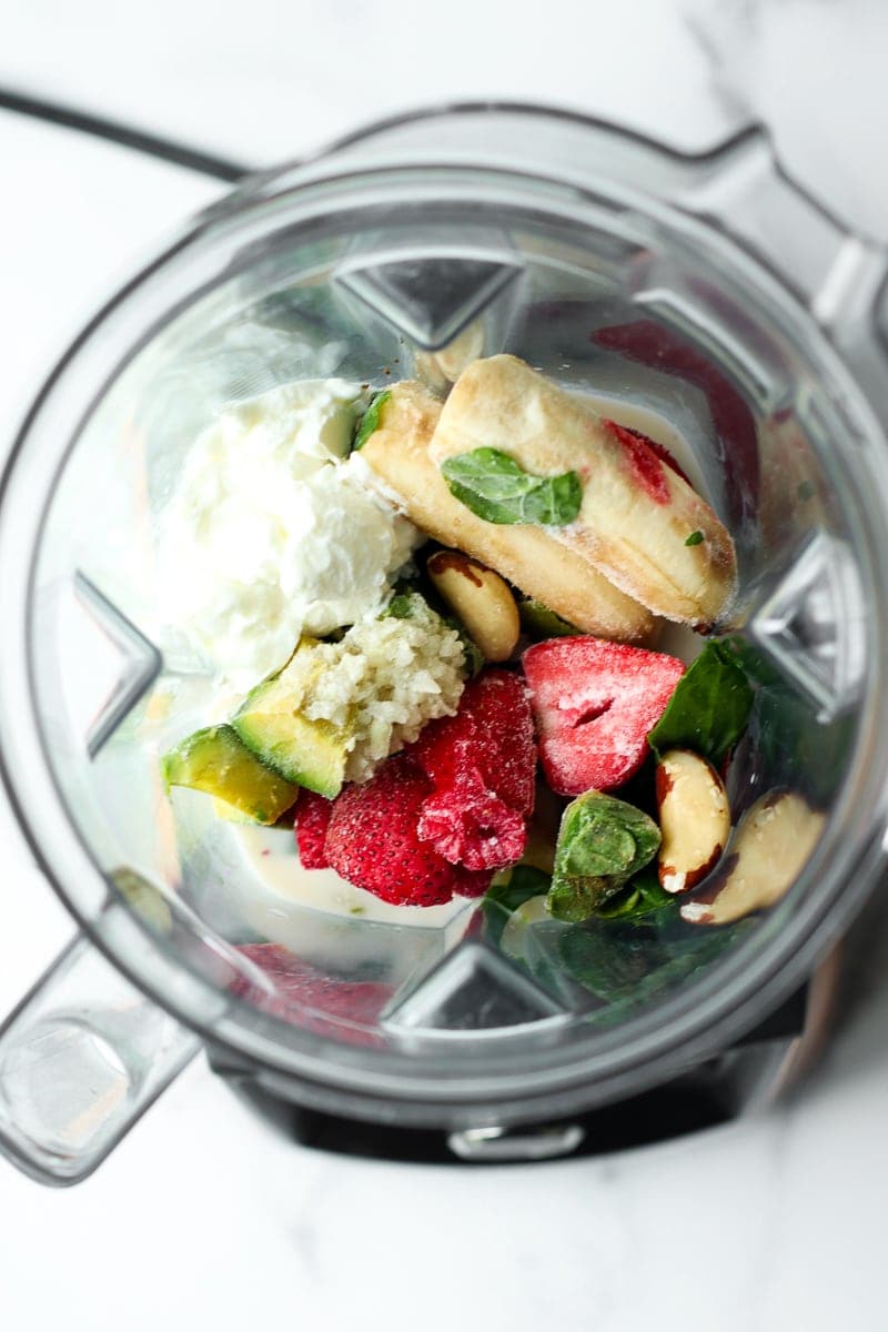 All ingredients for berry blast smoothie in a blender