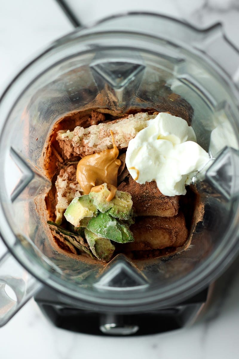 All ingredients for chocolate banana smoothie in a blender
