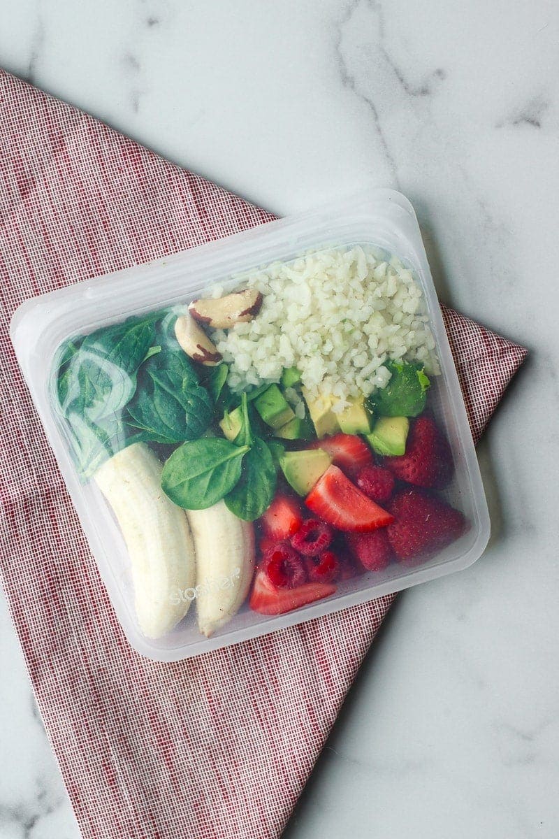 All ingredients for a berry blast smoothie in a reusable freezer bag