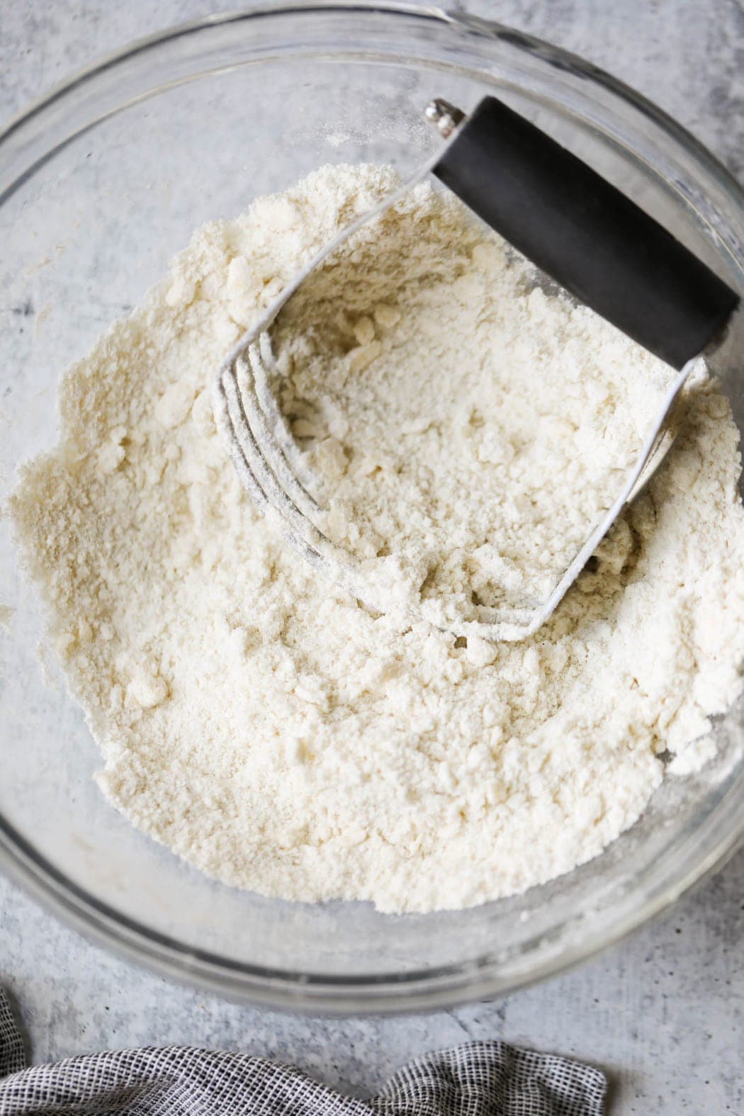 Gluten-free biscuits being cut in with a pastry cutter