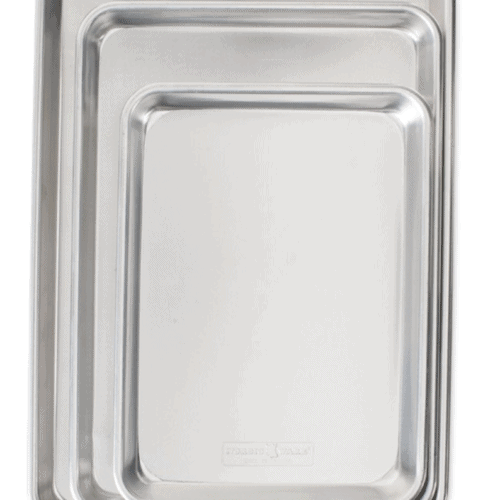 Three silver baking sheets nestled into each other on white background