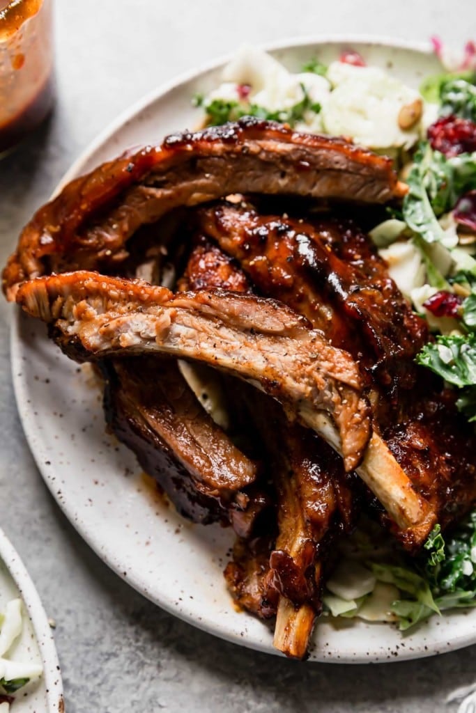A plate filled with Baby Back Ribs and a cole slaw salad