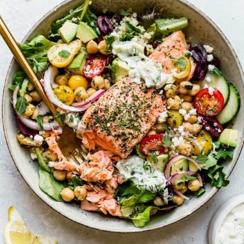 Overhead view Mediterranean flavored salad topped with salmon filet