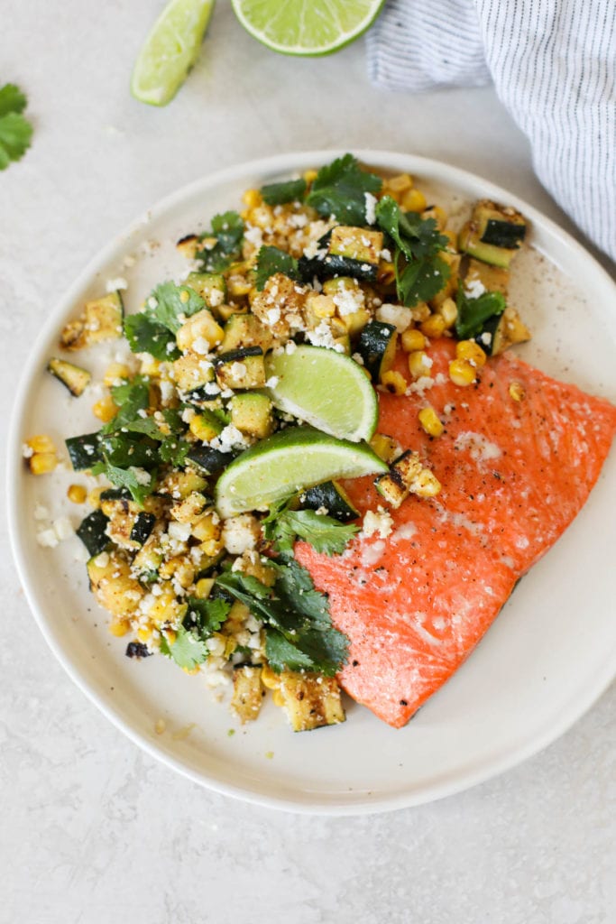 Overhead view of a plate of Grilled Salmon with Elote-Style Veggies