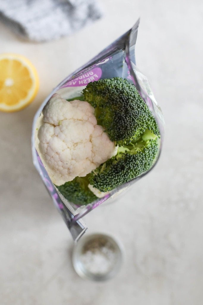 Overhead view of an open bag of broccoli and cauliflower florets