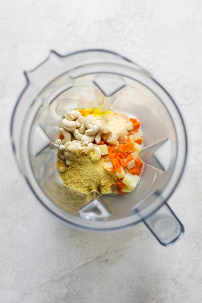 Overhead view of all ingredients for vegan cheese sauce in a blender