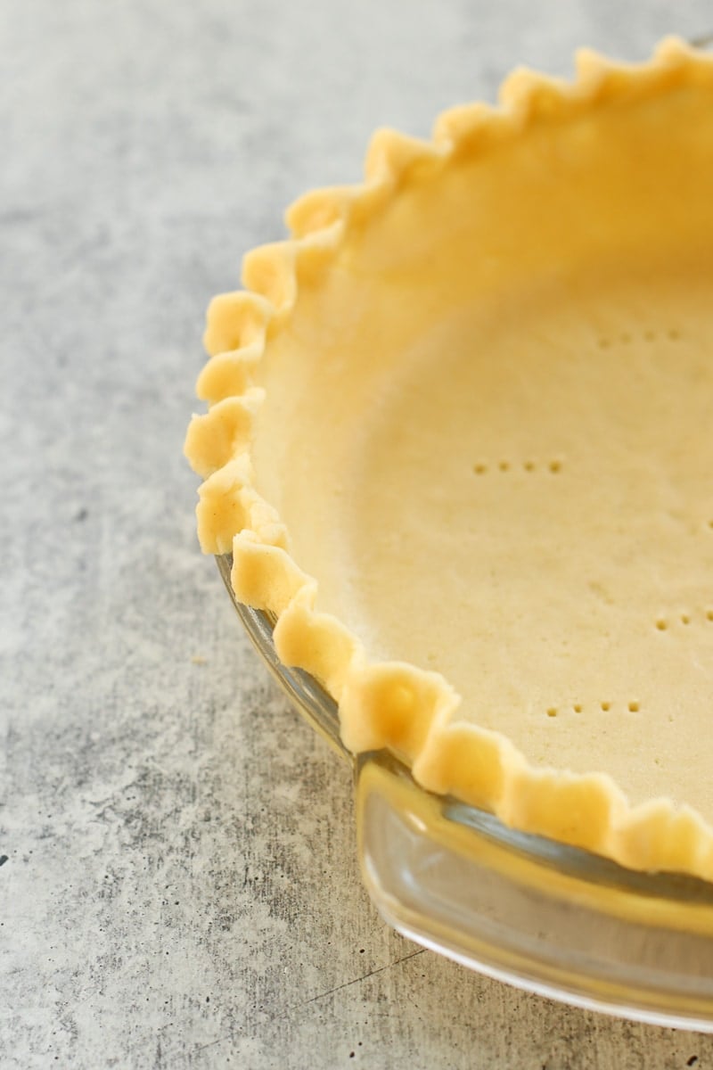 Close up view of a fluted edge gluten-free pie crust in a pie plate.