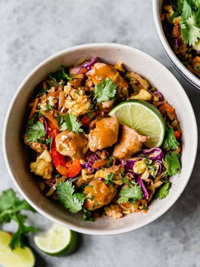 Overhead view of chicken pad Thai in a white bowl