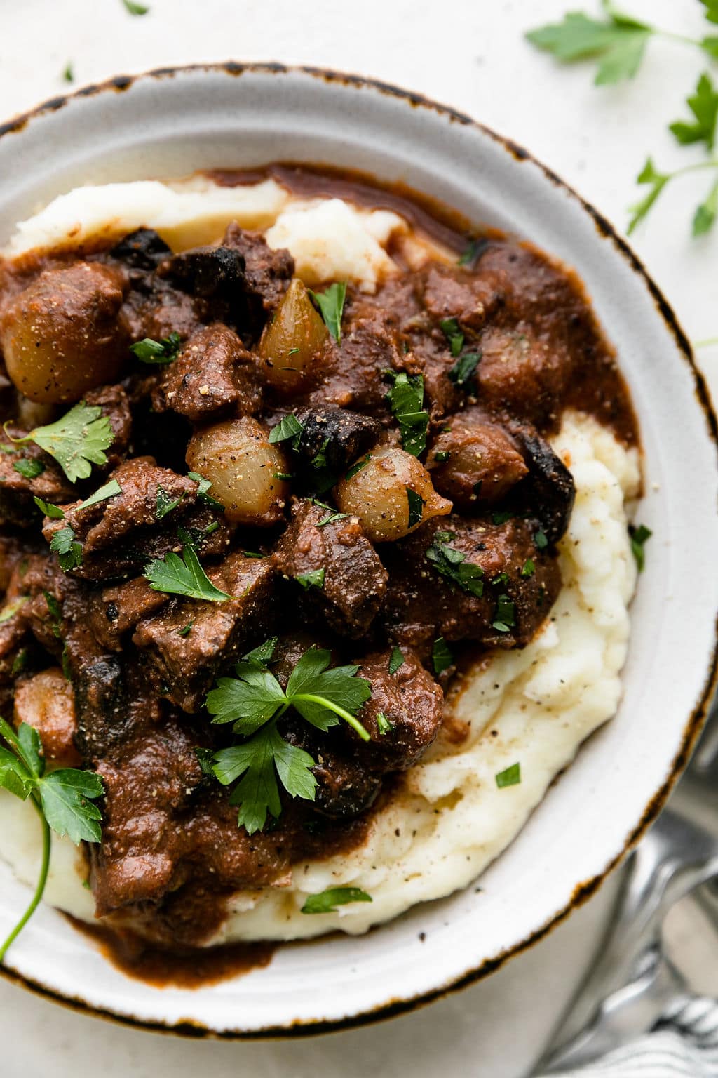Slow cooker beef tips served over mashed potatoes with gravy