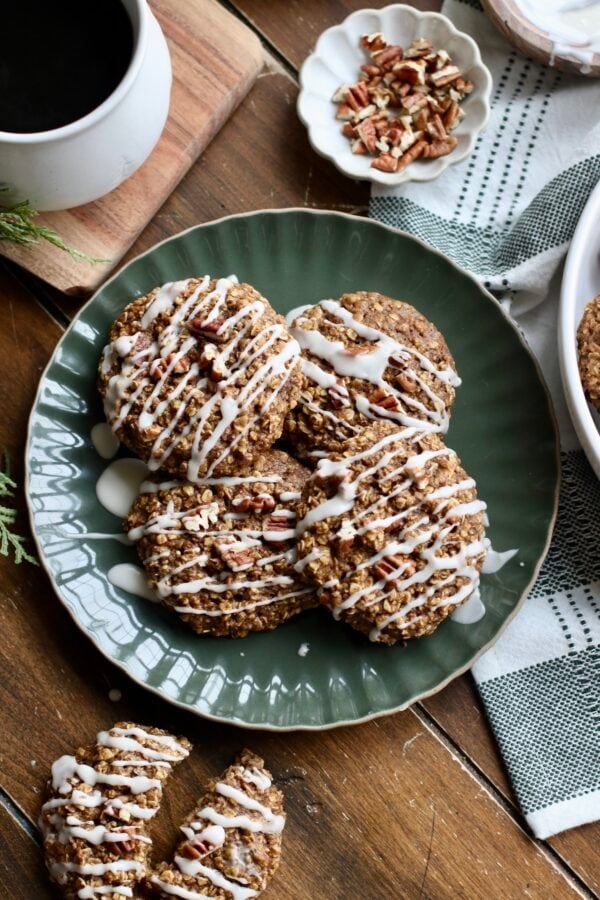 A green plate with 4 gingerbread breakfast cookies that are drizzled with white icing.