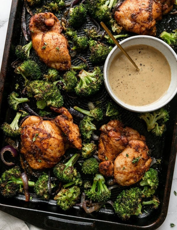 Overhead view sheet pan filled with chipotle chicken thighs and roasted broccoli