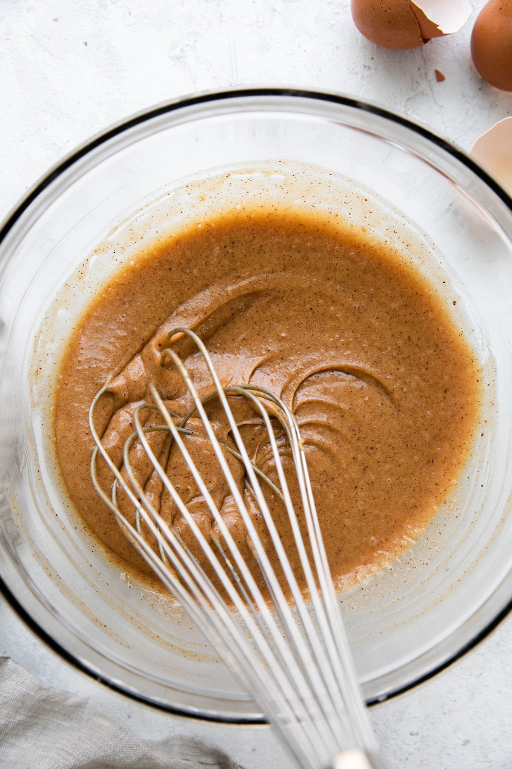 The batter for flourless chocolate donuts in a clear glass bowl.