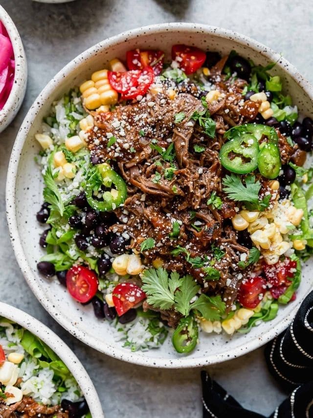 Overhead view of Instant Pot Beef Barbacoa served in a taco bowl