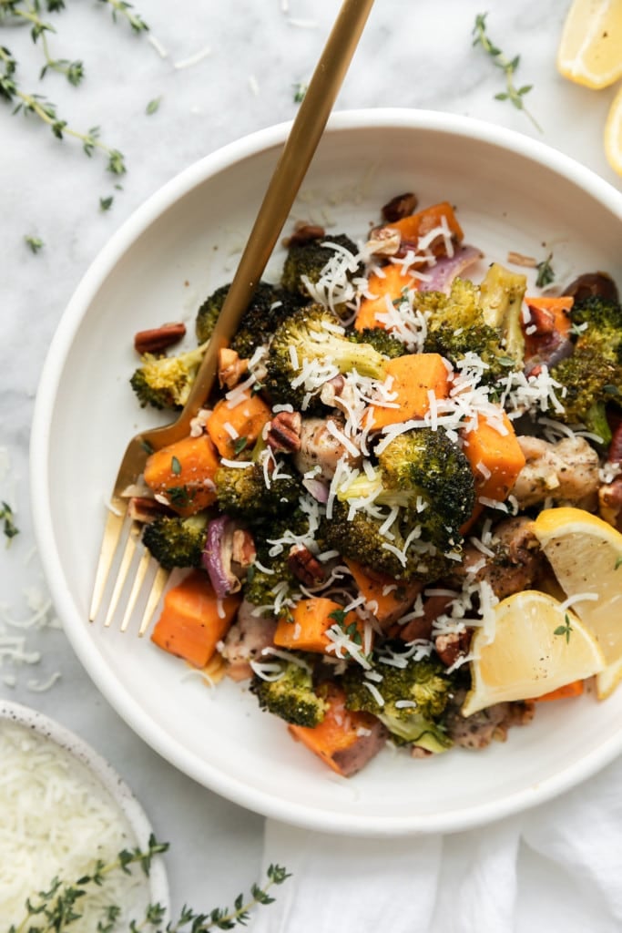 Sweet potato chicken broccoli bake plated on a white plate topped with fine mozzarella shreds.