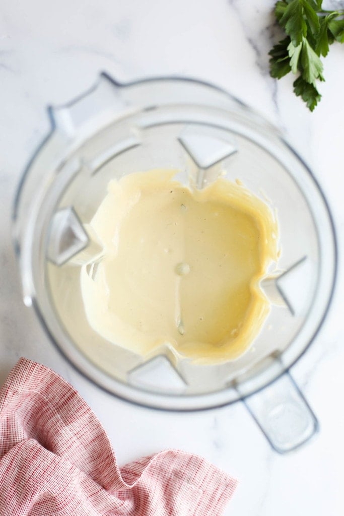 Overhead view of a blender filled with freshly blended Vegan Alfredo Sauce