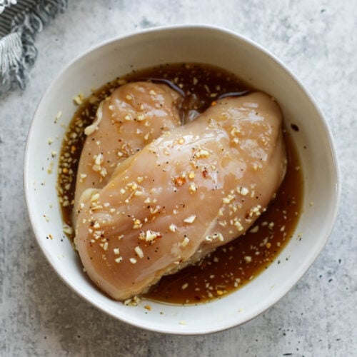 Overhead view of honey garlic chicken marinade in a white bowl.