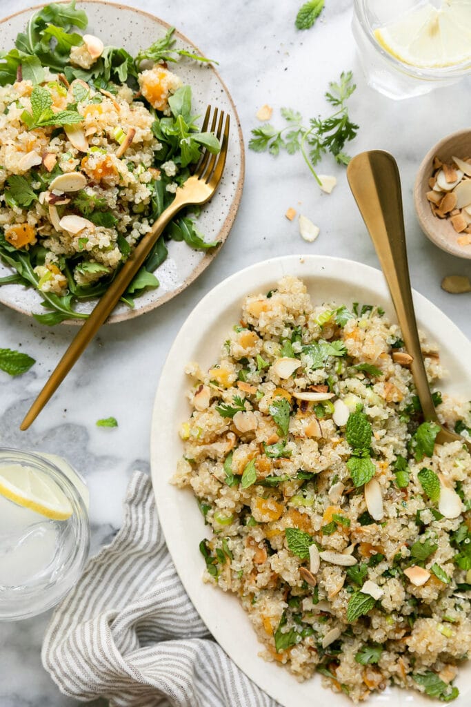 Herbed Quinoa Pilaf on white platter and serving on plate with arugula.