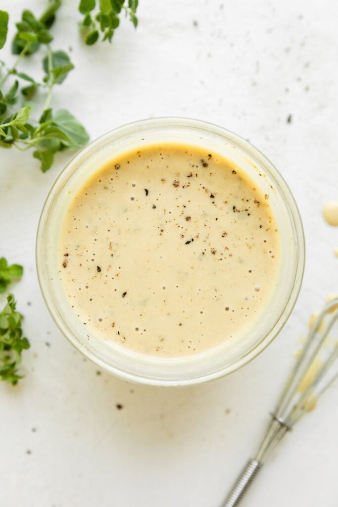 Overhead view maple dijon mustard in small glass jar.