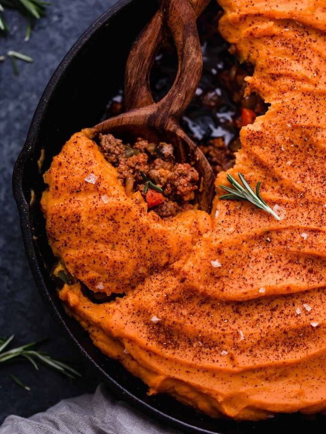 Overhead view shepherd's pie in cast iron skillet topped with mashed sweet potatoes.