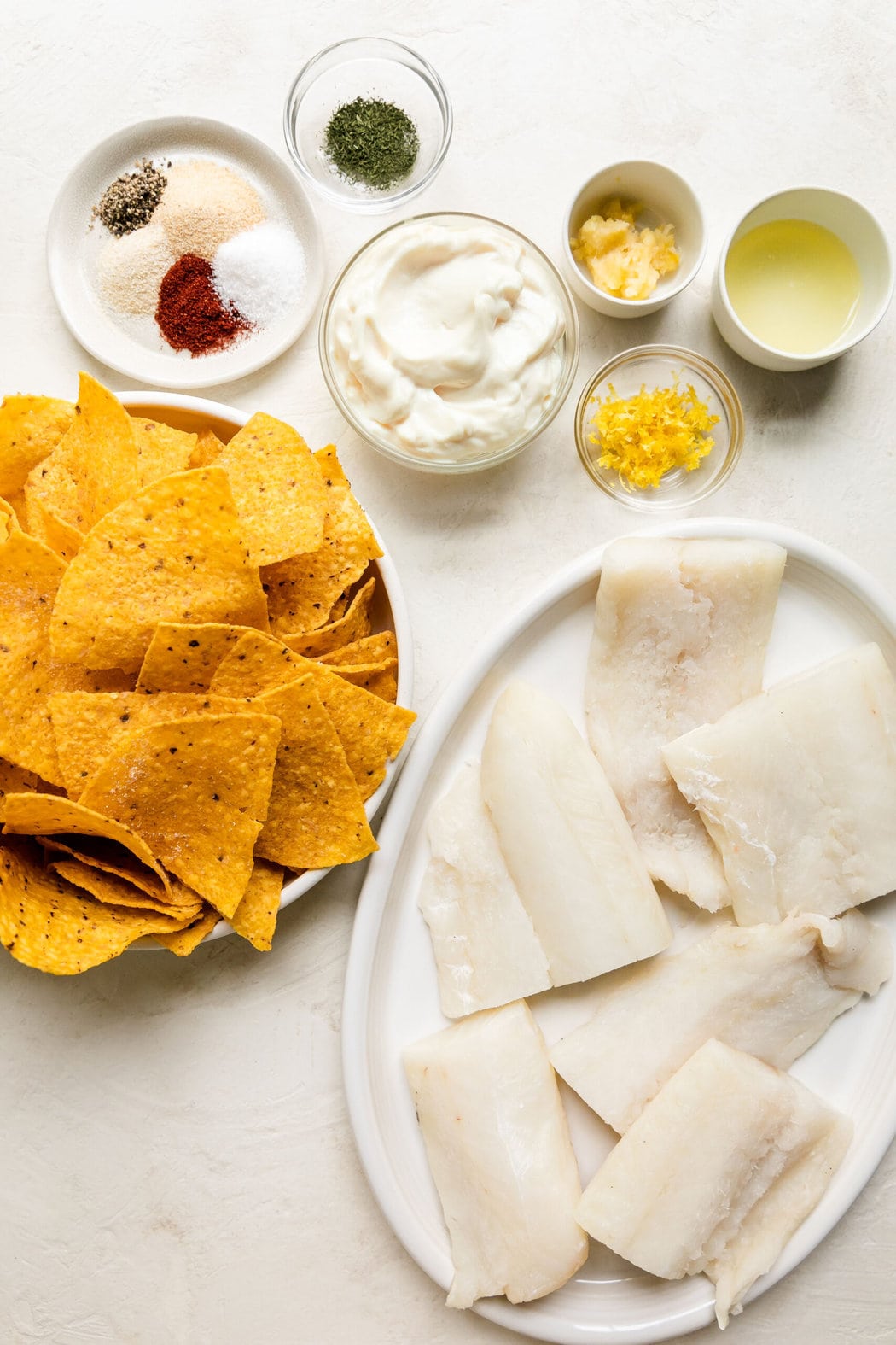 Overhead view all ingredients for homemade baked cod with aioli sauce.