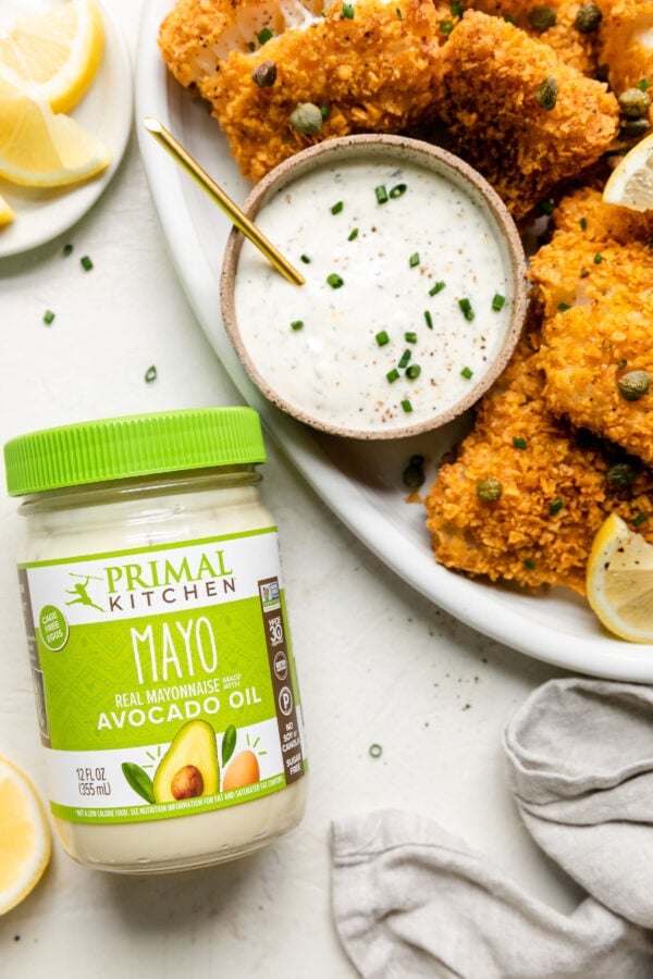 Crispy Baked Cod with Lemon-Garlic Aioli next to a jar of primal kitchen mayo